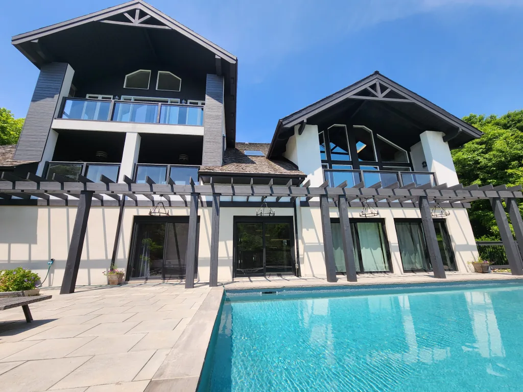 Painted contemporary GTA home exterior with dark timber and stucco details