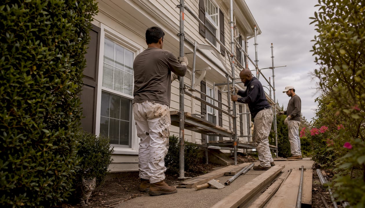Painting crew setting up scaffolding outdoors